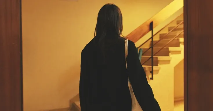A woman walking into her house | Source: Getty Images