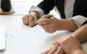 People sitting at a table with documents | Source: Shutterstock