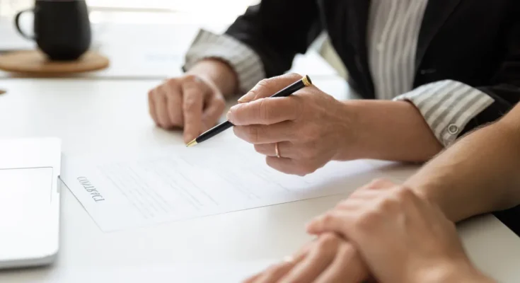 People sitting at a table with documents | Source: Shutterstock