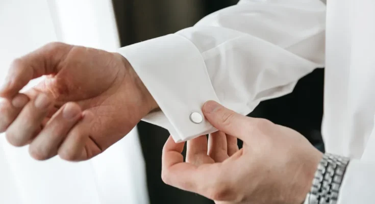 A groom adjusting his cufflink | Source: Shutterstock