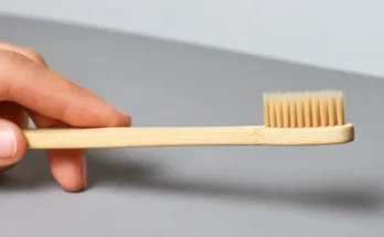 A person holding a toothbrush | Source: Shutterstock