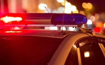 A police car with flashing red and blue lights at night | Source: Shutterstock