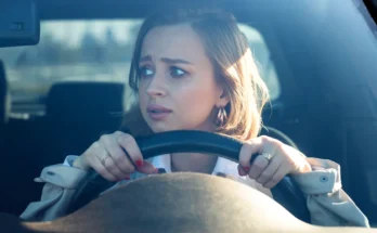 A young woman gripping the steering wheel, staring ahead with wide, anxious eyes | Source: Shutterstock