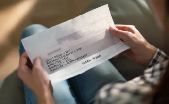 Woman holding the paper bill in her hands | Source: Midjourney