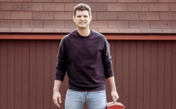 A man standing in front of a garage | Source: Shutterstock