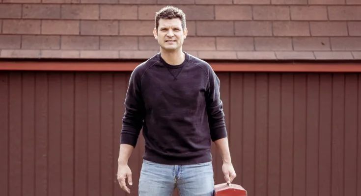 A man standing in front of a garage | Source: Shutterstock