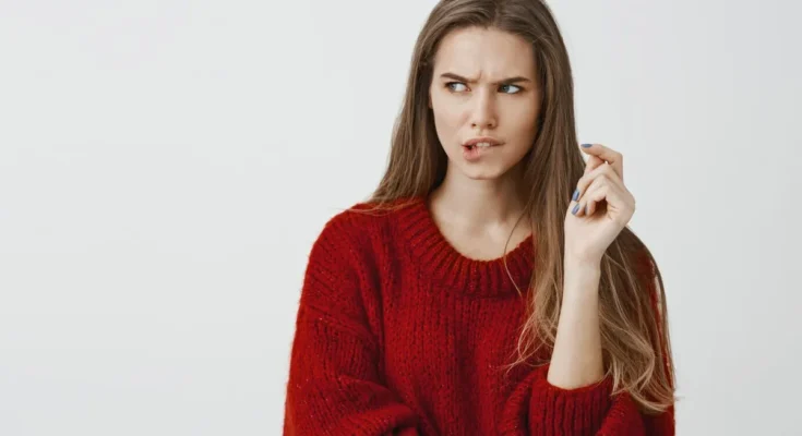 A young woman biting her lip | Source: Freepik