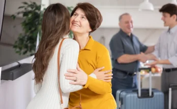 A young couple welcomes and older one | Source: Shutterstock