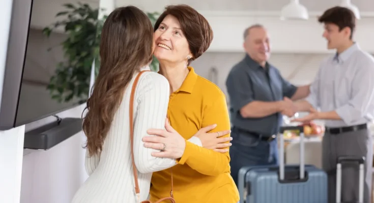 A young couple welcomes and older one | Source: Shutterstock