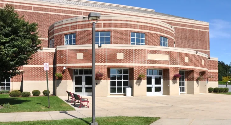 A large school building with brick walls and tall windows | Source: Shutterstock