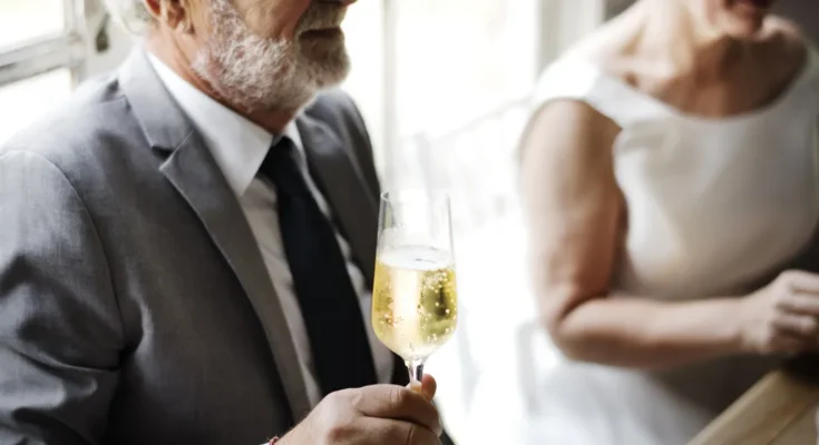 A man holding a flute of champagne | Source: Shutterstock
