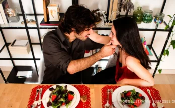A couple touching while having a romantic dinner | Source: Flickr.com