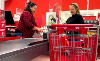 A female cashier serving a customer at a supermarket | Source: Shutterstock