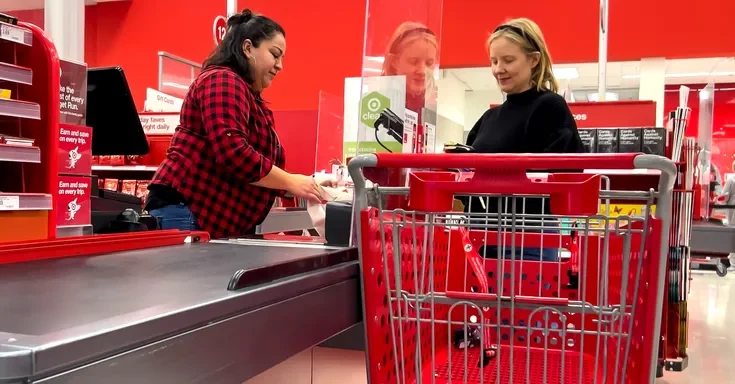 A female cashier serving a customer at a supermarket | Source: Shutterstock
