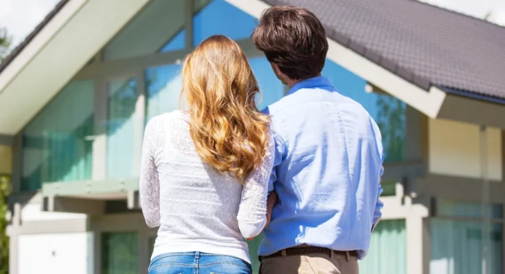 A couple staring at their dream home | Source: Shutterstock