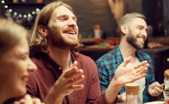 A man laughing with his friends | Source: Shutterstock