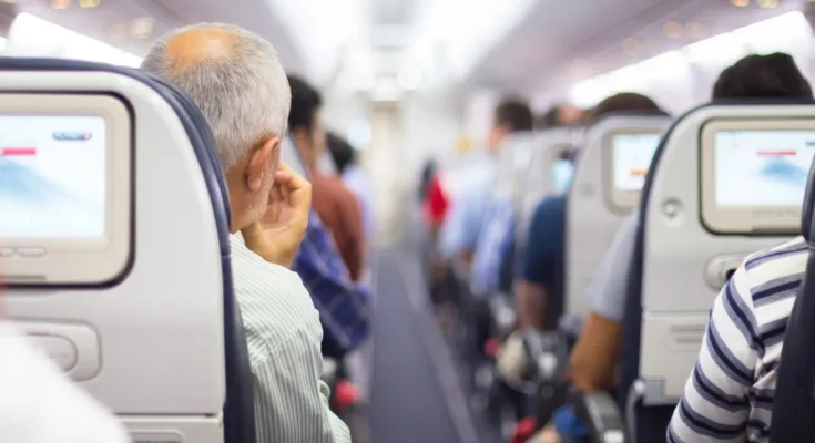 Passengers seated on a plane | Source: Shutterstock