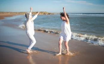 Two women dancing on the beach | Source: Pexels