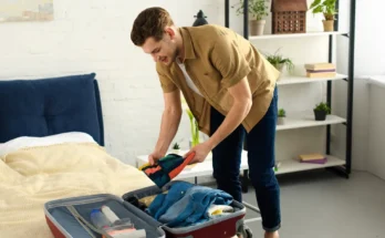 A man packing a suitcase | Source: Shutterstock