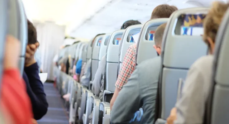 Passengers seated in economy class during a commercial flight | Source: Shutterstock