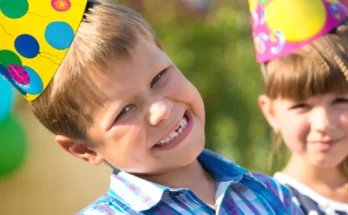 Kids enjoying a cheerful moment in party hats and sunshine | Source: Shutterstock