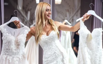 A woman holding white dresses | Source: Shutterstock