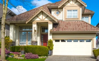 A suburban home with a red front door, manicured landscaping, and a bright, welcoming exterior | Source: Shutterstock
