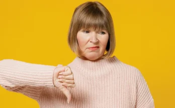 An unhappy woman giving a thumbs down sign | Source: Shutterstock