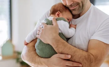 A man holding a baby | Source: Shutterstock