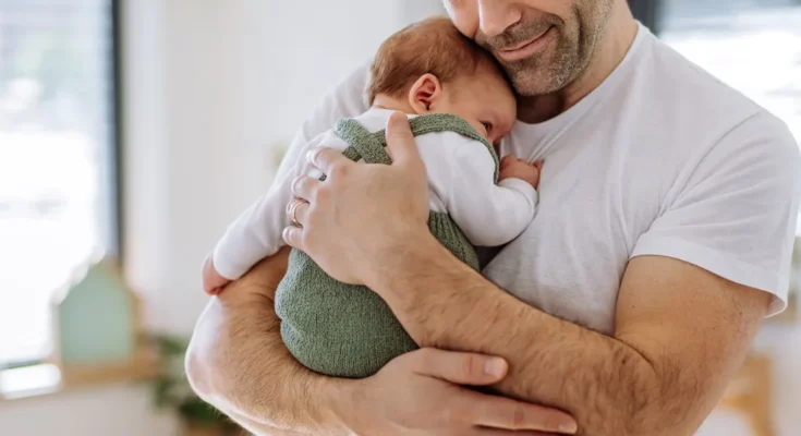 A man holding a baby | Source: Shutterstock