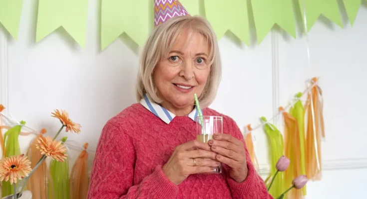 A woman attending a birthday celebration | Source: Freepik