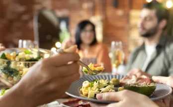People sitting at a dinner table | Source: Freepik