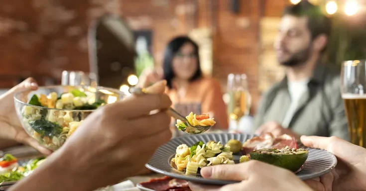 People sitting at a dinner table | Source: Freepik