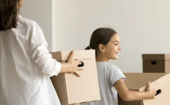 A woman and her daughter holding boxes | Source: Shutterstock