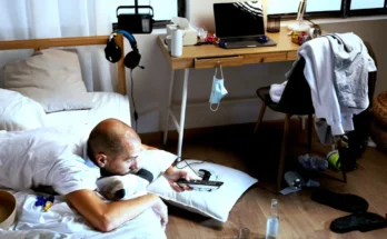 A man lying on a bed in a dirty room | Source: Freepik.com