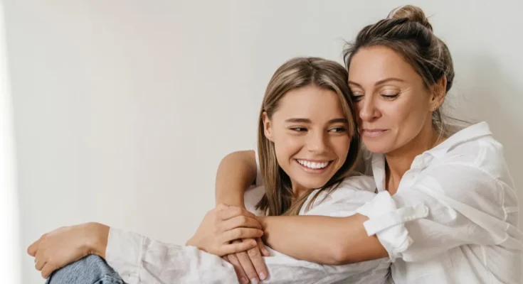 A woman hugging her teen daughter | Source: Shutterstock