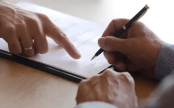 Someone signing paperwork | Source: Shutterstock