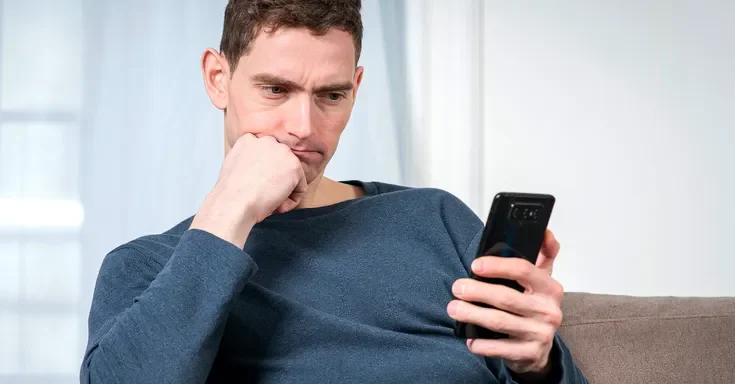 A man holding a phone | Source: Shutterstock