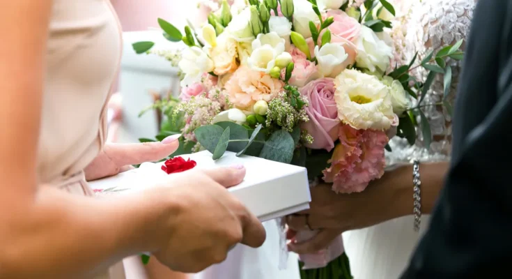 A person giving a bride a gift | Source: Shutterstock
