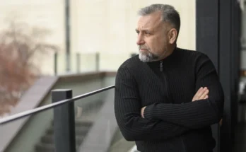 A stern man standing on a balcony | Source: Freepik