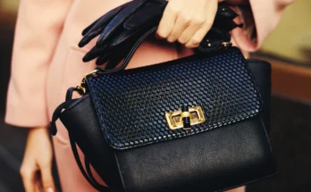 A woman holding a designer handbag | Source: Shutterstock