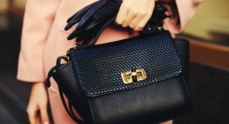 A woman holding a designer handbag | Source: Shutterstock